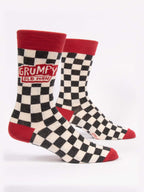 Blue Q Grumpy Old Man M-Crew Socks feature a black-and-white checkered design with red cuffs, heels, and toes, plus a playful red patch reading “GRUMPY OLD MAN” in white text.