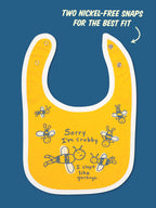 The Blue Q "Sorry I’m Crabby. I Slept Like Garbage." Lunch Chucker Bib is a yellow cotton baby bib with white trim, cartoon bees, two nickel-free snaps for adjustable fit, and an absorbent design for both cuteness and practicality.