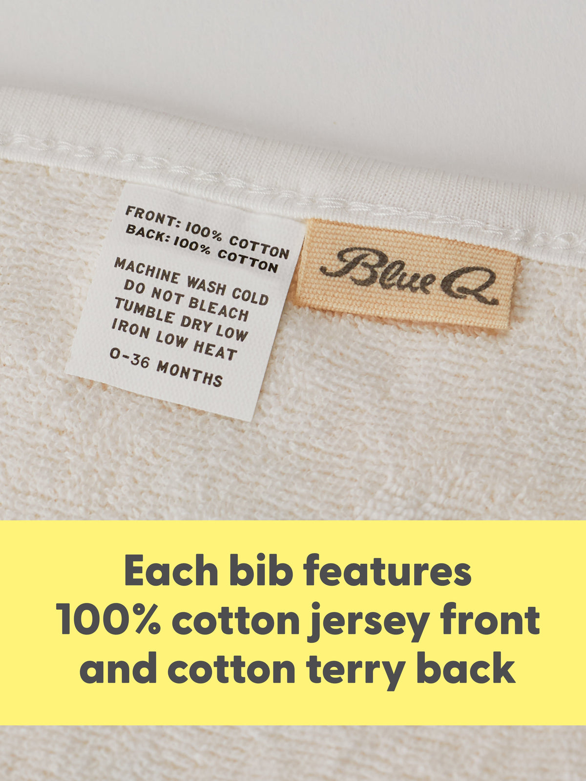 Close-up of a Blue Q "Sorry I'm Crabby. I Slept Like Garbage./ Lunch Chucker Bib" with care and brand labels, above a yellow banner: Each bib features an absorbent jersey front and soft terry cotton back.