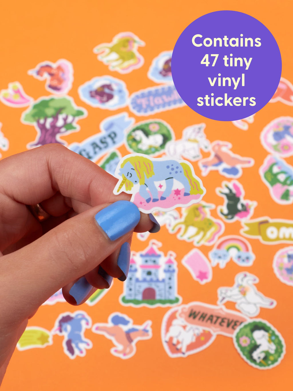 A hand holds an Overly Dramatic Unicorns Playtime Sticker Set unicorn sticker on a cloud, with various unicorn designs scattered on an orange surface and a purple circular graphic reading, Contains 47 tiny vinyl stickers.