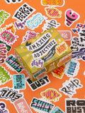 An Amazing Adjectives Playtime Sticker Set box surrounded by loose stickers featuring a collection of words in colorful fonts and graphic styles used for ascribing qualities.