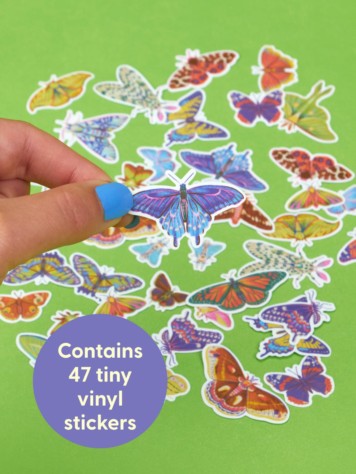 A hand holds a Some Of These Are Butterflies And Some Are Actually Moths Playtime Sticker Set butterfly sticker over various Lepidopterans on a green background, with a purple circular graphic stating it contains 47 tiny vinyl stickers.