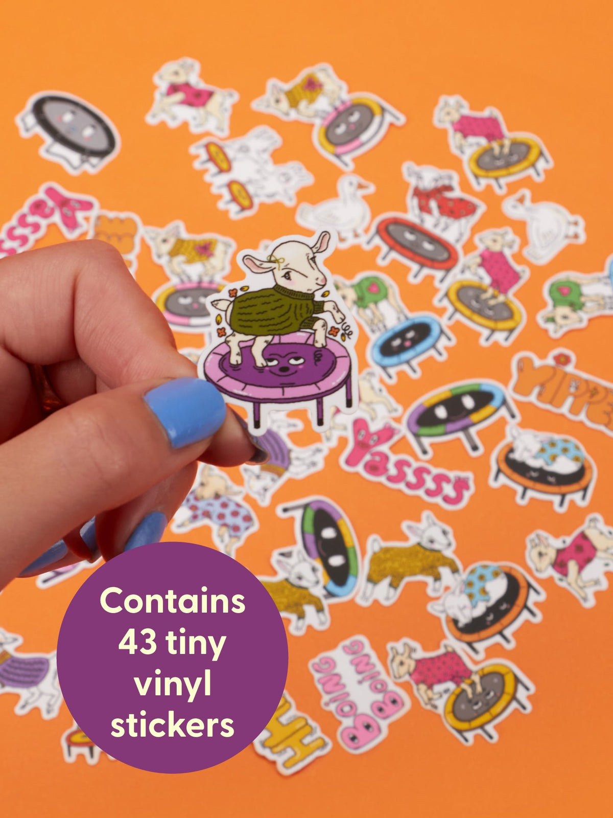 A hand holds a Baby Goats On Trampolines Wearing Sweaters Playtime Sticker Set goat sticker on a trampoline, surrounded by a collection of similar bouncing toy stickers on an orange background.