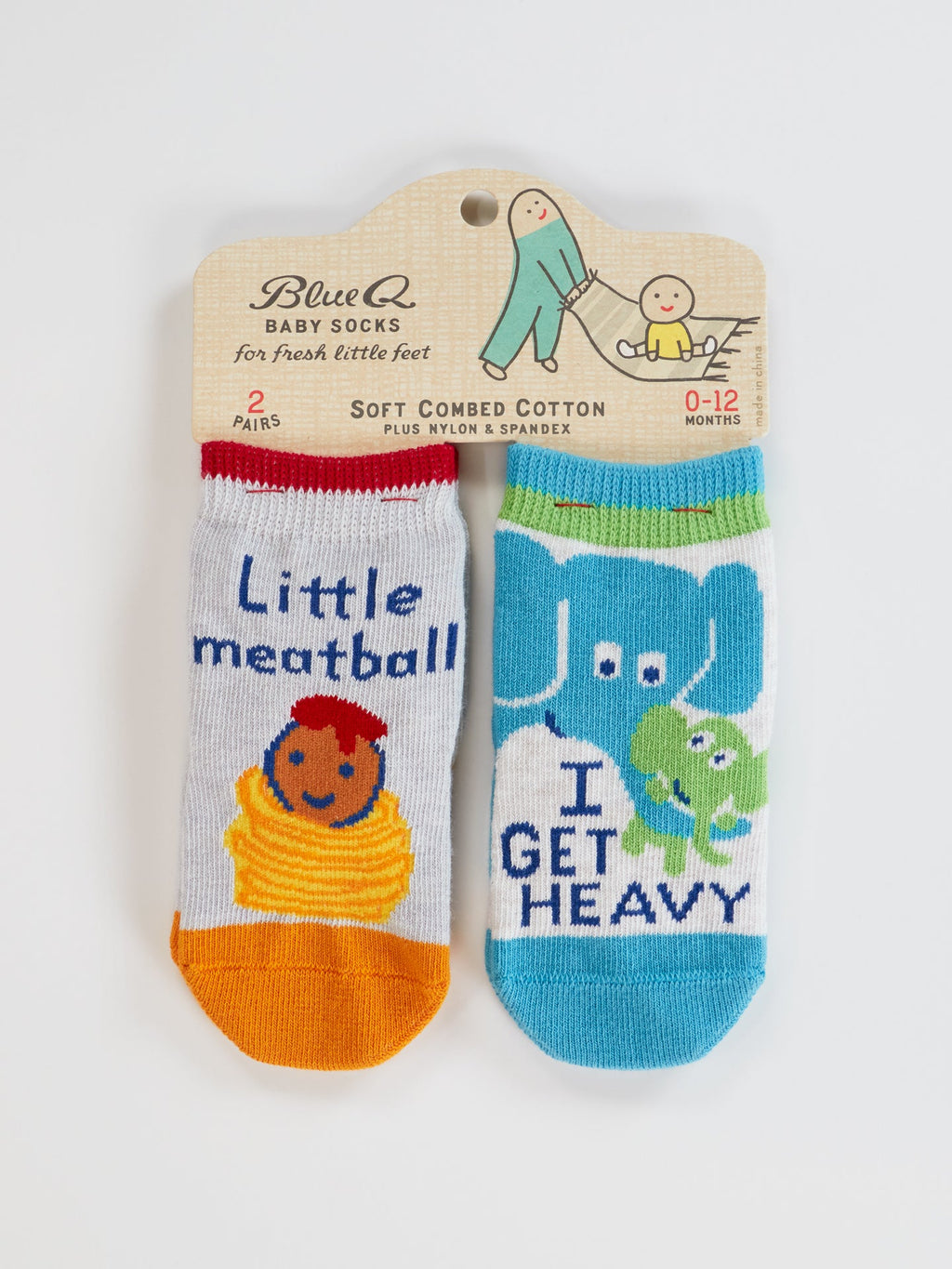 Blue Q's Little Meatball/I Get Heavy Baby Socks: two pairs for babies—one white & orange cotton pair with spaghetti, meatball design, and “Little meatball” text; one blue & white pair with elephant, frog, and “I GET HEAVY.”.