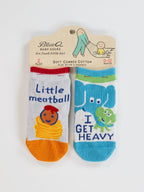 Blue Q's Little Meatball/I Get Heavy Baby Socks: two pairs for babies—one white & orange cotton pair with spaghetti, meatball design, and “Little meatball” text; one blue & white pair with elephant, frog, and “I GET HEAVY.”.
