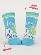 Blue Q's Little Meatball/ I Get Heavy Baby Socks feature playful elephant and alligator designs in blue and white cotton. Text reads "I GET HEAVY," with labels "SUPER STRETCHY!" and "SO COMFY!"—perfect spandex socks for kids' comfort and play.