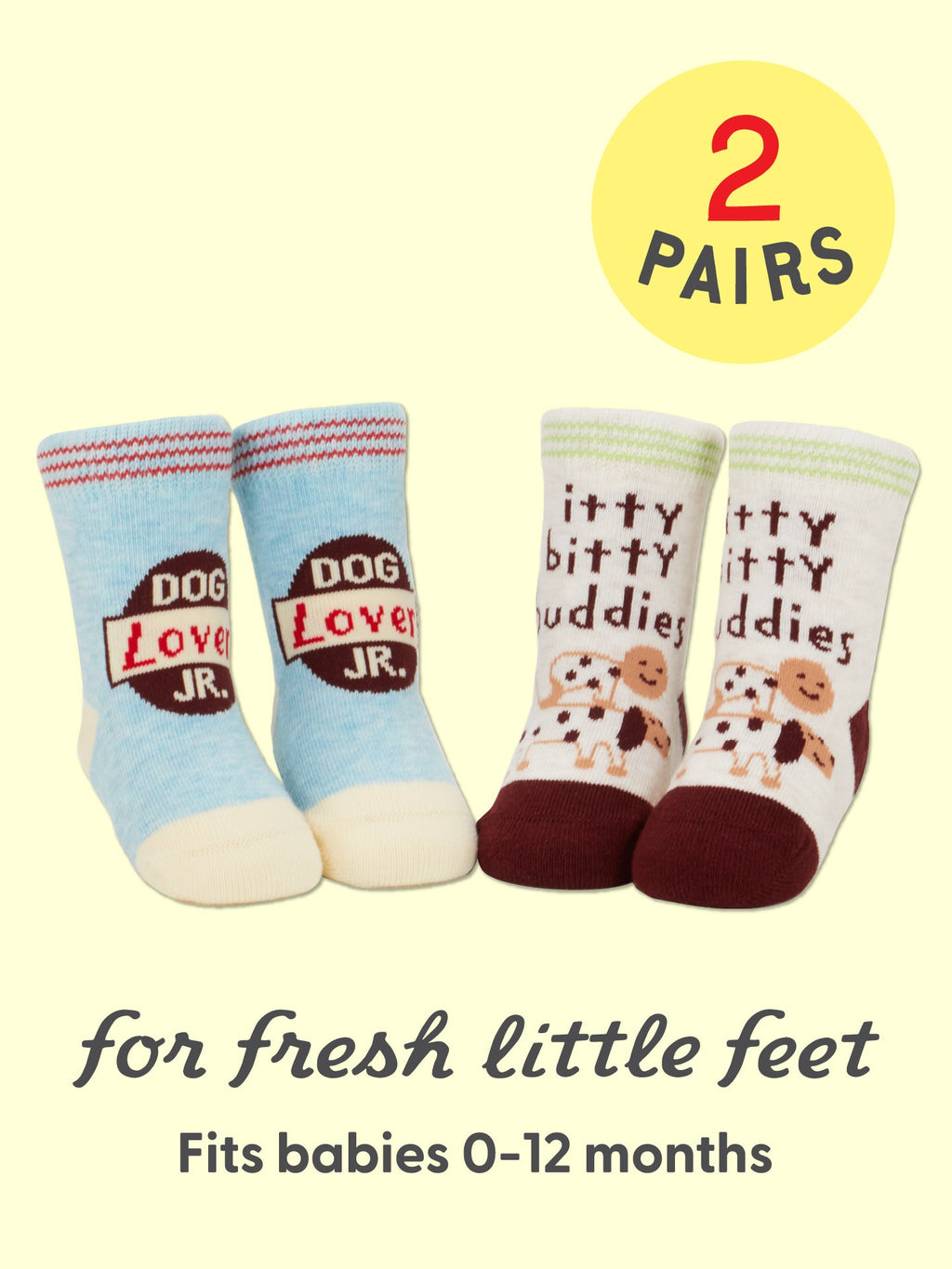 Keep your little one’s toes cozy with Blue Q’s Dog Lover Jr./Itty Bitty Buddies Baby Socks—two pairs designed for 0-12 months. Featuring one blue and cream pair with “Dog Lover JR.”, and another in cream and burgundy with playful dogs and itty bitty buddies, each set is crafted from soft organic cotton for all-day comfort. Text reads: 2 pairs for fresh little feet.