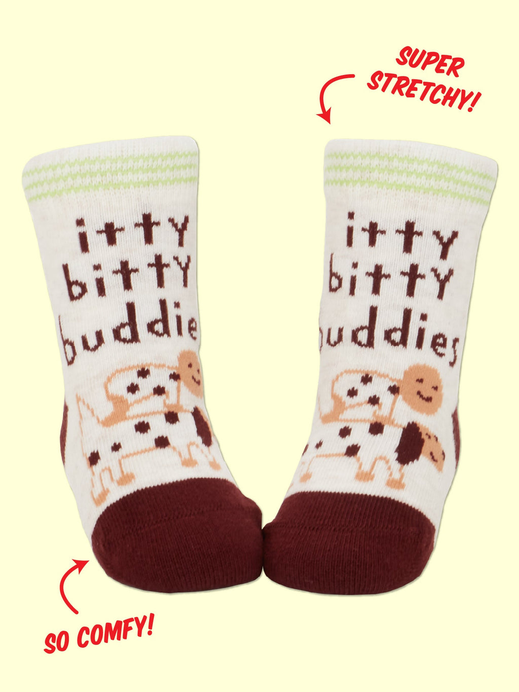 Slip on the Blue Q Dog Lover Jr./ Itty Bitty Buddies Baby Socks—white organic cotton socks with maroon toes and cuffs, decorated with playful cartoon dogs and “itty bitty buddies” text. Designed to be SUPER STRETCHY! and SO COMFY!, they’re perfect for you and your besties or favorite companions.