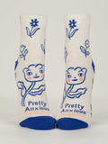 Blue Q's Pretty Anxious W-Ankle Socks fit women's shoe sizes 5-10. These white combed cotton socks feature blue toes and heels, cheerful pink-cheeked flowers, and “Pretty Anxious” on the sole.